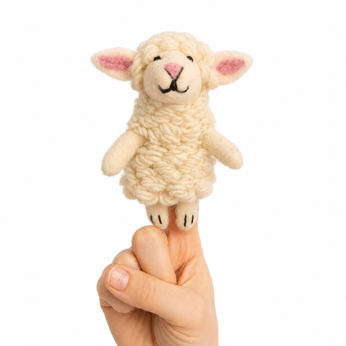 A small cream-colored felt sheep toy with pink inner ears and a black stitched face, held on a person's finger against a plain white background.